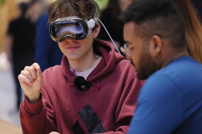 A person tries out an Apple Vision Pro headset at an Apple store in New York City on Feb. 2.