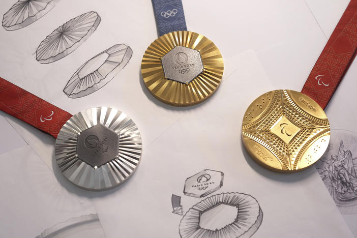 The Paris 2024 Olympic gold medal, center, the Paris 2024 Paralympic, gold medal, right, and silver medal, left, are presented to the press, in Paris, Thursday, Feb. 1, 2024.