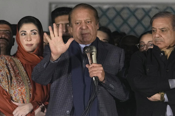 Pakistan's former Prime Minister Nawaz Sharif (center) addresses supporters next to his brother, Shehbaz Sharif (right) and daughter Maryam Nawaz following initial results of the country's parliamentary election, in Lahore, Pakistan, Friday.