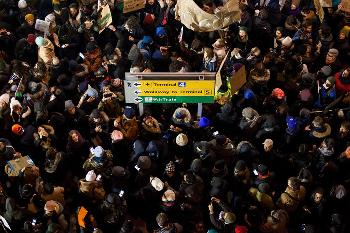 Demonstrators gather outside of John F. Kennedy International Airport airport in New York to protest shortly after former President Donald Trump's executive order blocking visitors from seven predominantly Muslim nations went into effect in January 2017. Trump is promising to implement even more extreme immigration policies if he wins another term in November.