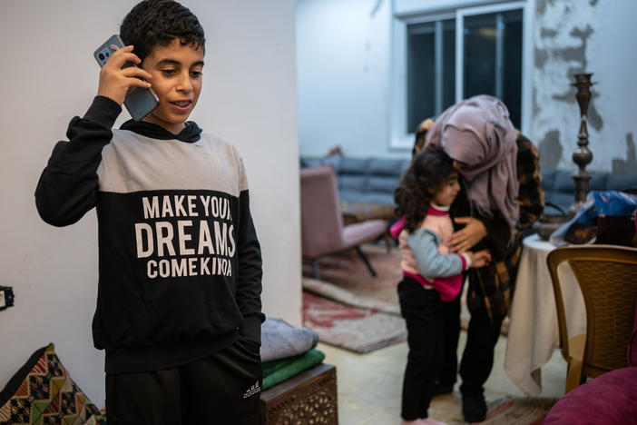 Ibrahim, 12, speaks to his grandmother, who lives in Gaza, from his home in Ramallah in the Israeli-occupied West Bank on Jan. 31. The family did not want to use their full names out of fear of reprisals from Israeli authorities.