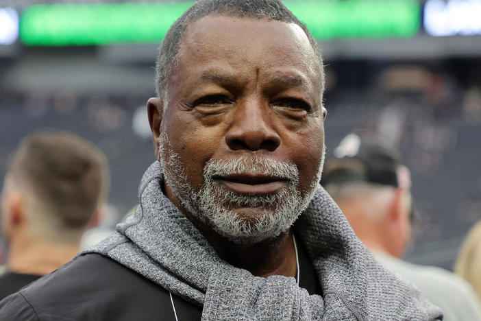 Carl Weathers stands on the sidelines before a Las Vegas Raiders game against the Houston Texans at Allegiant Stadium in Las Vegas in October 2022. He made a posthumous cameo in a 2024 Super Bowl ad.
