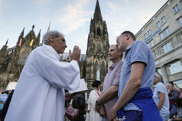 A same-sex couple receives a blessing in front of Germany's Cologne Cathedral in September 2023, a few months before Pope Francis officially declared such blessings allowable.