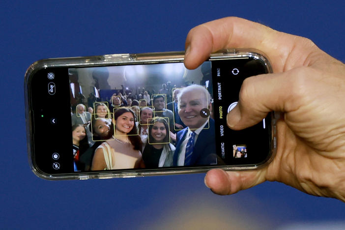 President Biden takes a selfie using a guest's phone during an event at the University of Tampa on Feb. 9, 2023.