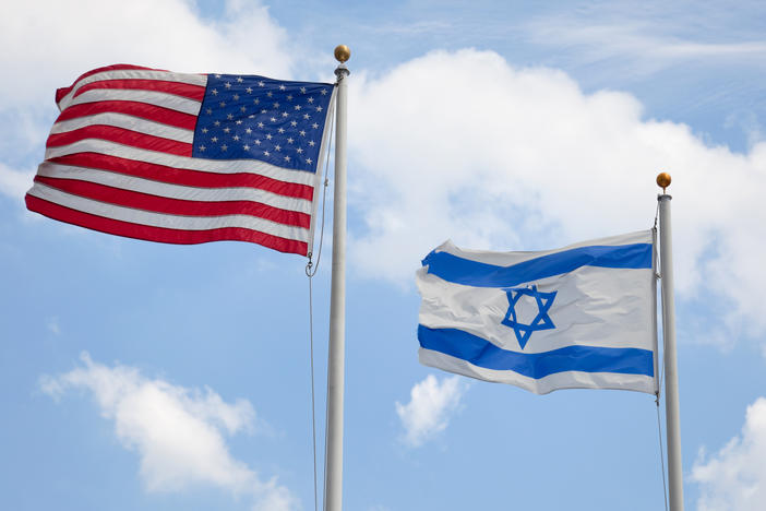 U.S. and Israeli flags wave together. Nearly half of U.S. Jewish respondents to a survey commissioned by the American Jewish Committee say they've changed their behavior due to fear. The survey was conducted in October and November 2023.