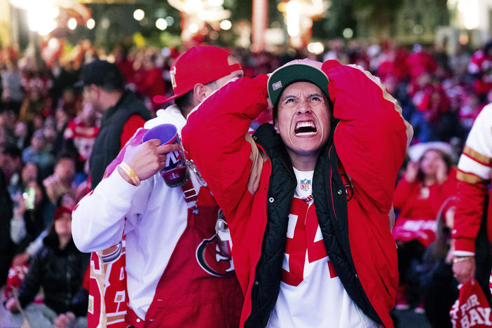 A San Francisco 49ers fan reacts while watching a telecast of NFL football's Super Bowl 58 on a screen outside the Chase Center in San Francisco on Sunday, Feb. 11, 2024.
