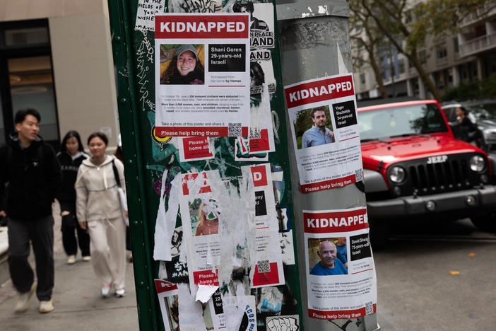 Posters of some of those kidnapped by Hamas in Israel are displayed on a pole in Manhattan.