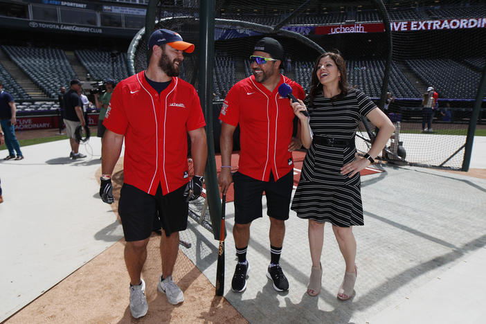 Colorado Rockies television announcer Jenny Cavnar, right, jokes with Vinny Castilla, center, special assistant to the Rockies general manager, and Denver Broncos fullback Andy Janovich after they took part in the UC Healthy Swings Charity Home Run Derby Tuesday, June 11, 2019, in Coors Field in Denver.