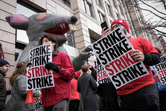 <em>Washington Post</em> staff picket during a 24-hour strike outside the newspaper's building in December 2023.