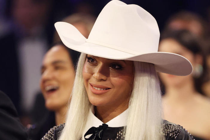 Beyoncé watches Jay-Z as he accepts the Dr. Dre Global Impact Award during the 66th Grammy Awards on Feb. 4.