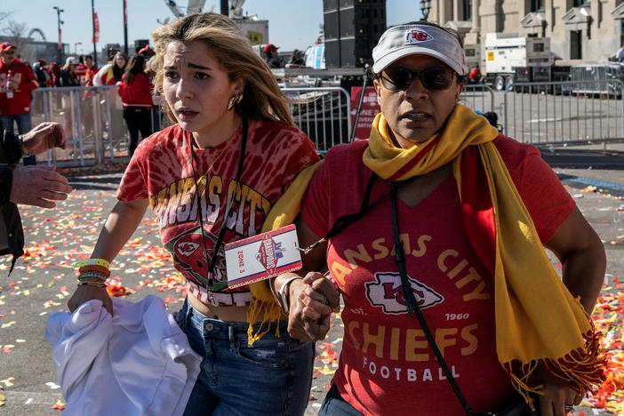 People flee after gunshots were fired near the Kansas City Chiefs' Super Bowl victory parade on Feb. 14 in Kansas City, Missouri.