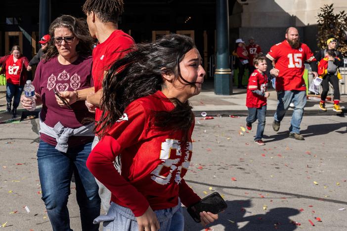 People flee after shots were fired near the Kansas City Chiefs' Super Bowl victory parade on Wednesday in Kansas City, Mo.
