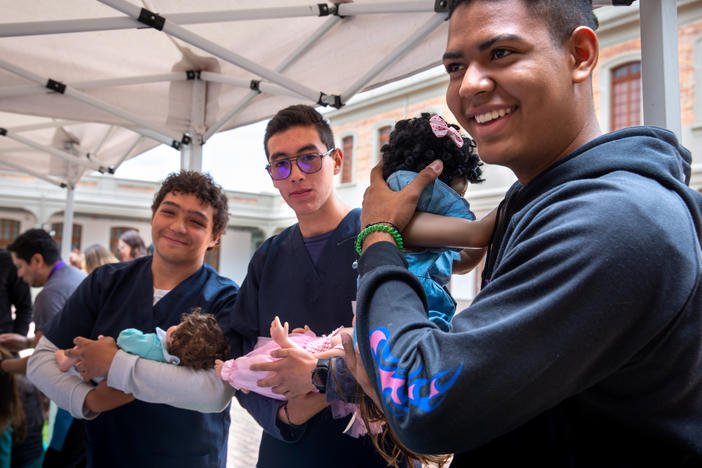 At a one-day workshop run by the Care School for Men in Bogotá, Colombia, male medical students at Sanitas University learn how to cradle a baby. This class of participants consists of medical students, but the usual enrollees are dads of all types.