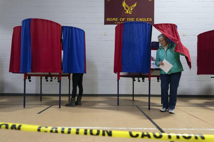 A voter leaves a polling booth at St. Anthony Community Center in Manchester, N.H., during the state's presidential primary on Jan. 23.