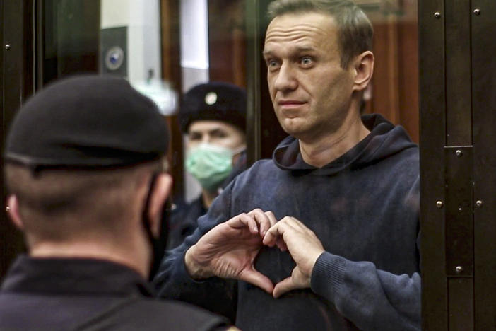 Feb. 21, 2021: Russian opposition leader Alexei Navalny shows a heart symbol standing in the cage during a hearing to a motion from the Russian prison service to convert the suspended sentence of Navalny from the 2014 criminal conviction into a real prison term in the Moscow City Court in Moscow, Russia.
