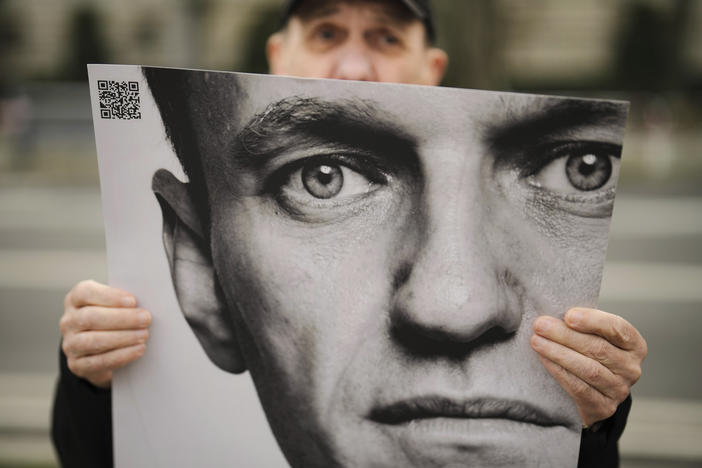 A man holds a poster with a portrait of opposition leader Alexei Navalny during a protest in front of the Russian Embassy in Berlin on Friday. Navalny, who crusaded against official corruption and staged massive anti-Kremlin protests as President Vladimir Putin's fiercest foe, died Friday in the Arctic penal colony, Russia's prison agency said.