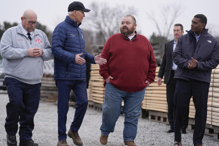 President Biden talks with East Palestine, Ohio Mayor Trent Conaway during a tour of the site where a train carrying toxic chemicals derailed a year ago.