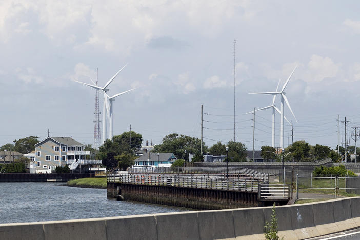 Wind turbines are visible from the highway in Atlantic City, New Jersey. The state and the country are betting big  on offshore wind power as a means to combat climate change.