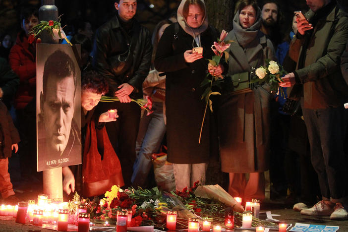Protesters light candles on Friday in front of the Russian Embassy in Prague after the announcement that the Kremlin's most prominent critic, Alexei Navalny, had died in an Arctic prison.