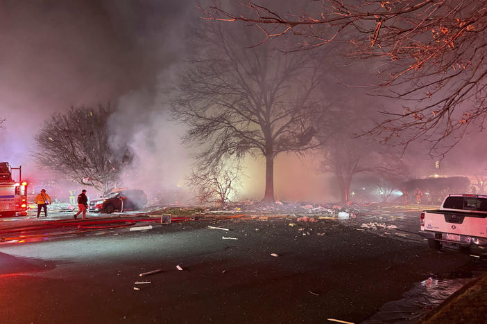 First responders arrive at the scene after an explosion at a house late Friday in Sterling, Va.