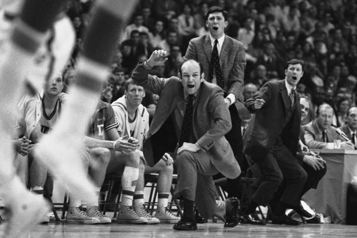 Davidson head coach Lefty Driesell drops to a knee in front of his bench as he watches North Carolina win an NCAA Eastern Regional basketball tournament at College Park, Md., on March 15, 1969. Driesell, the coach whose folksy drawl belied a fiery on-court demeanor that put Maryland on the college basketball map, died Saturday.