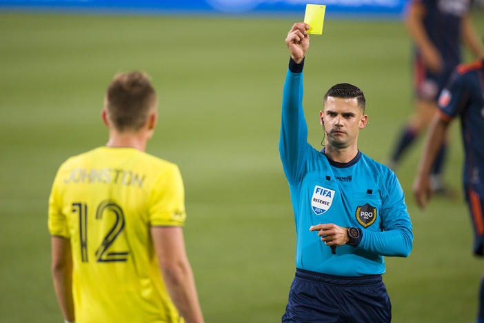 Alistair Johnston of Nashville SC is issued a yellow card during the second half of a match against FC Cincinnati at Nissan Stadium on April 17, 2021 in Nashville.
