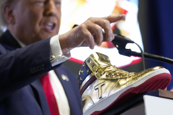 Republican presidential candidate Donald Trump unveils his golden high-tops on Saturday at Sneaker Con Philadelphia, an event popular among sneaker collectors.