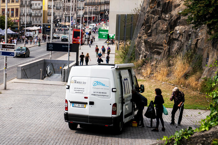 Drug consumers line up outside of the SAOM van for a methadone cocktail and supplies in the city center of Porto, Portugal last spring.  There are very few overdose deaths in the country where drug addiction is treated as an illness rather than a crime.<a href="https://www.gettyimages.com/license/924064702?adppopup=true"></a>