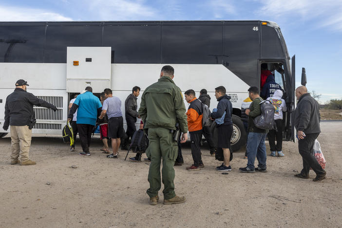 Immigrants file into a U.S. Customs and Border Protection bus after crossing the U.S.-Mexico border on January 07, 2024 in Eagle Pass, Texas.