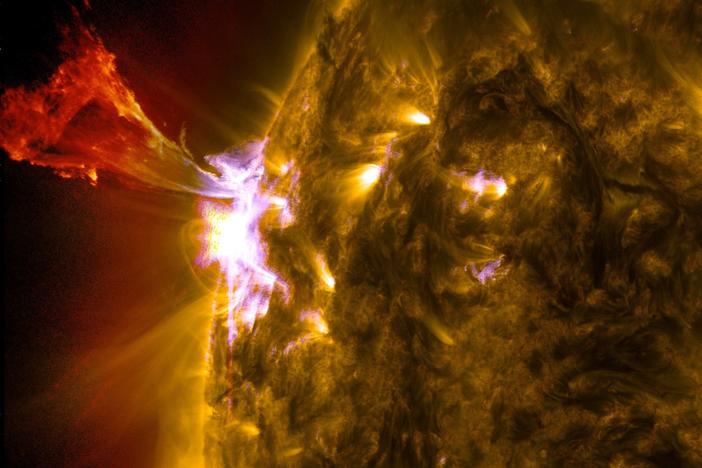 The sun emits a mid-level solar flare releasing a burst of solar material.<strong></strong>