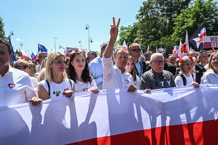 Donald Tusk (center), then in the opposition, marches with Warsaw Mayor Rafal Trzaskowski (left) and former President Lech Walesa (right) in a protest last year organized by Civil Platform, the coalition of political parties now running Poland's government.