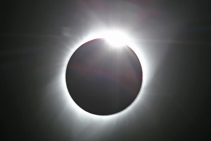 The sun is shown in the first phase of a total eclipse in this photo taken in August 2017 from Grand Teton National Park outside Jackson, Wyo.