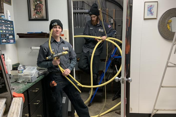 Danny Luckman and Aidan Czerniak of Simply Installs Heating & Air Conditioning cut out and remove natural gas lines from a tattoo and piercing shop. To meet climate change goals, Ithaca, New York wants to switch from gas to electric in the city's 6000 buildings.