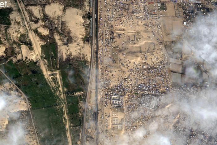 This Feb. 18 satellite photo shows displaced Palestinians crammed into southern Gaza on the right. Israel is threatening to attack the border town of Rafah, where more than 1 million Palestinians are now living. On the left is the vast, empty expanse of Egypt's Sinai Peninsula. Egypt says it won't allow Palestinians into Egypt because it fears they might not be allowed back into Gaza.