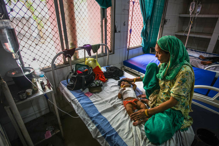 A 7-month-old child with diarrhea lies in a bed at a hospital in India. Oral rehydration salts are a cheap and effective treatment but are underused. A new study aims to find out why.