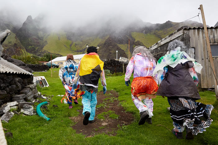 A group of Okalolies head toward a house belonging to one of their own in Edinburgh of the Seven Seas on Tristan da Cunha, in the South Atlantic Ocean, on Dec. 31, 2023. New Year's Eve, or Old Year's Night as it's known on the island, is a chance for the whole community to come together.