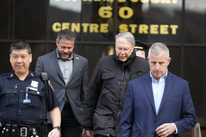 Former NRA CEO Wayne LaPierre (second from right) leaves New York State Supreme Court on Wednesday. Top NRA executives for were accused of using millions in donations for private luxuries.