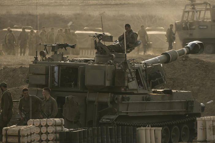 Israeli soldiers sit on an artillery unit near the Israeli border with the Gaza Strip, in Netivot, Israel, Oct. 22.