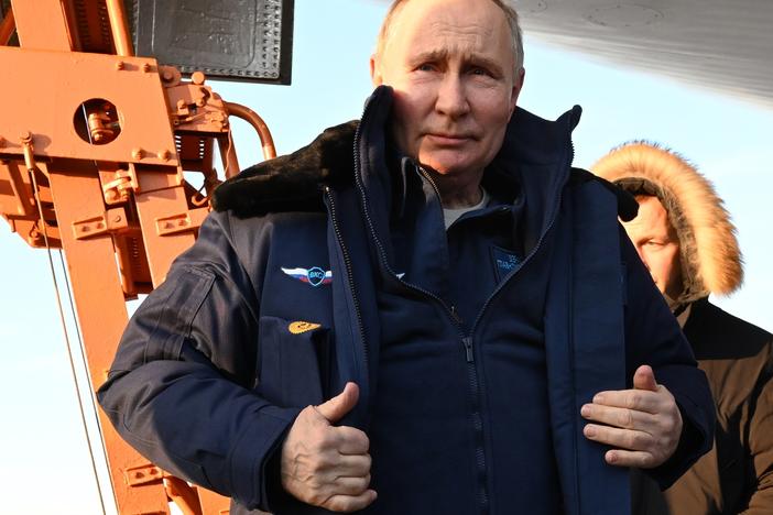 Russian President Vladimir Putin gets off a Tu-160M strategic bomber after a flight in Kazan, Russia, on Thursday.