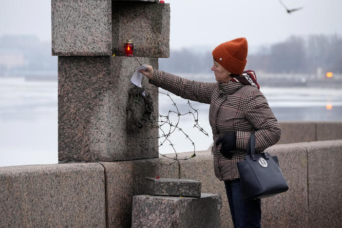 A woman places a piece of paper with words of grief for Alexei Navalny paying the last respect to him at the Memorial to Victims of Political Repression in St. Petersburg, Russia, on Saturday.