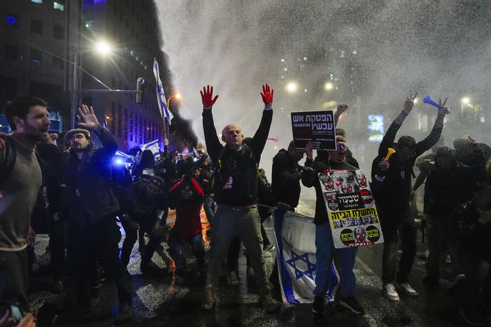 Police in Tel Aviv, Israel, use water cannons to disperse demonstrators during a protest against Israeli Prime Minister Benjamin Netanyahu's government, and calling for the release of hostages held in the Gaza Strip by Hamas, on Saturday.