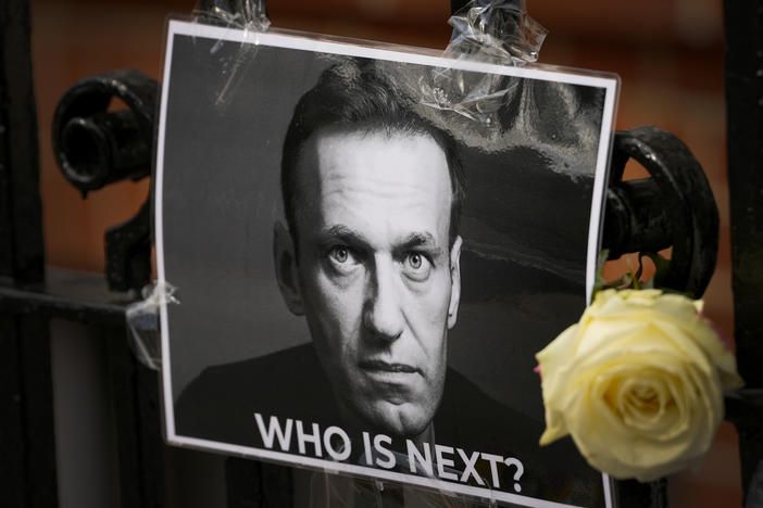 A flower and a picture are left as a tribute to Russian politician Alexei Navalny, near the Russian Embassy in London, Feb. 18.