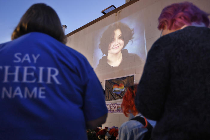 A photograph of Nex Benedict, a nonbinary teenager who died one day after a fight in a high school bathroom, is projected during a candlelight service at Point A Gallery, Saturday, Feb. 24, 2024, in Oklahoma City.
