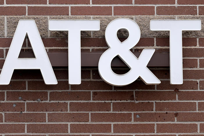 The company logo hangs over the door to an AT&T store Thursday, Feb. 22, 2024, in Denver.