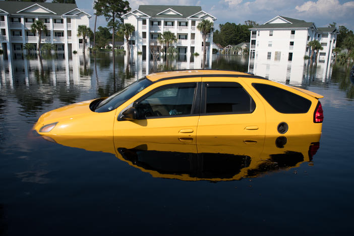 Climate change makes intense floods, wildfires, hurricanes and heat waves more common. Recovering from a disaster can be expensive. Here, a flooded car after Hurricane Florence hit South Carolina in 2018.