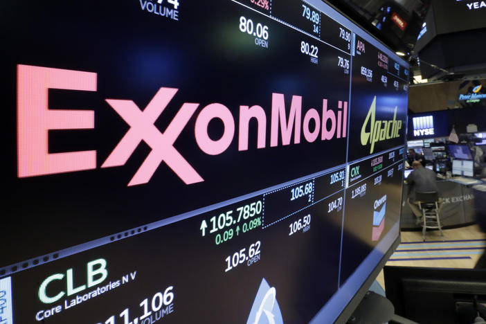 The ExxonMobil logo appears above a trading post at the New York Stock Exchange.