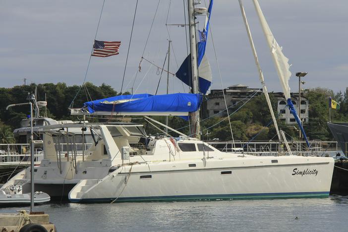 The yacht "Simplicity", that officials say was hijacked by three escaped prisoners with two people aboard, is docked at the St. Vincent and the Grenadines Coastguard Service Calliaqua Base, in Calliaqua, St. Vincent, on Friday.