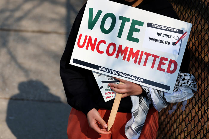 A Democratic voter uncommitted to President Biden rallies outside of a polling location at Maples Elementary School on Feb. 27 in Dearborn, Mich.