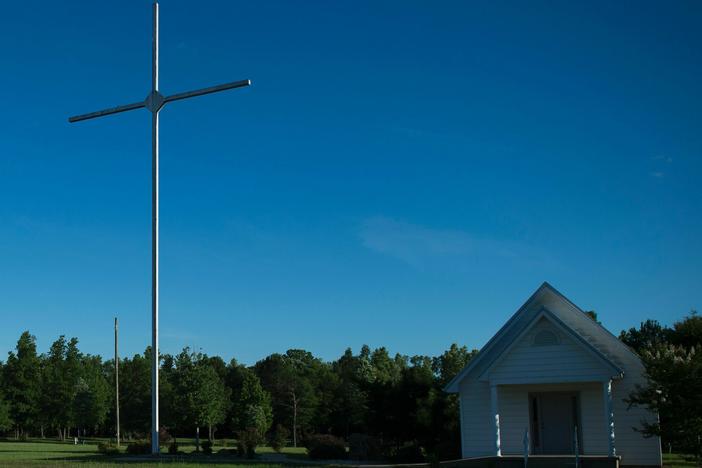 A giant cross next to a small church in Vance, Alabama. The state is among those where views supporting Christian nationalism are the strongest in the country, according to a new survey.