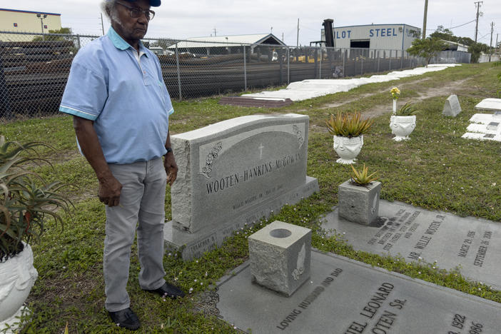 Elijah Wooten stands near the graves of many of his family members at the Westview Community Cemetery.